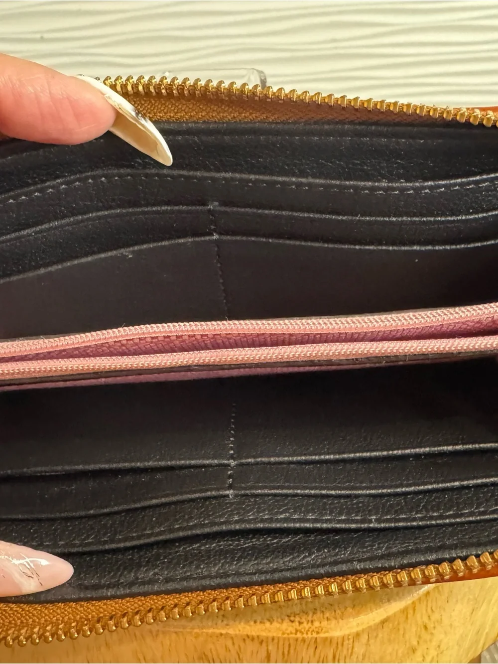 Dooney & Bourke Black Pebbled Leather Zip Wallet with Tan Trim and Logo Plate